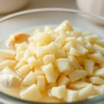 Fresh Minced Garlic in water displayed in a glass bowl, highlighting purity and quality for