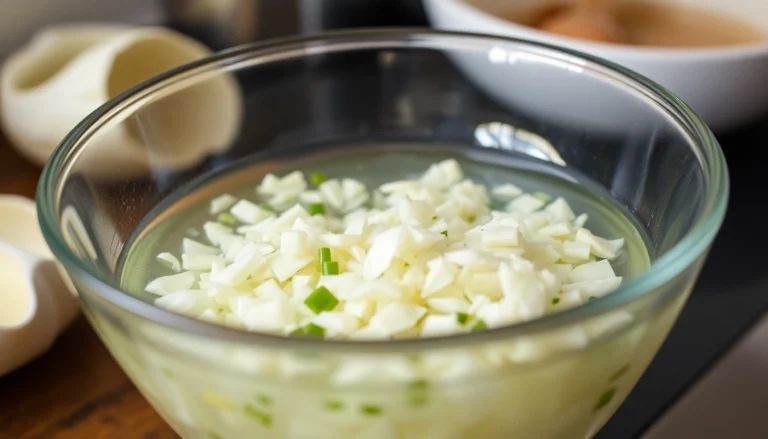 Close-up of minced garlic in water being stirred in a glass bowl, highlighting freshness and